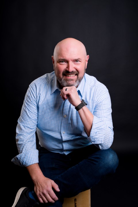 Headshot of Jim Perry, an experienced AI coach and technology leader, smiling in a professional setting.